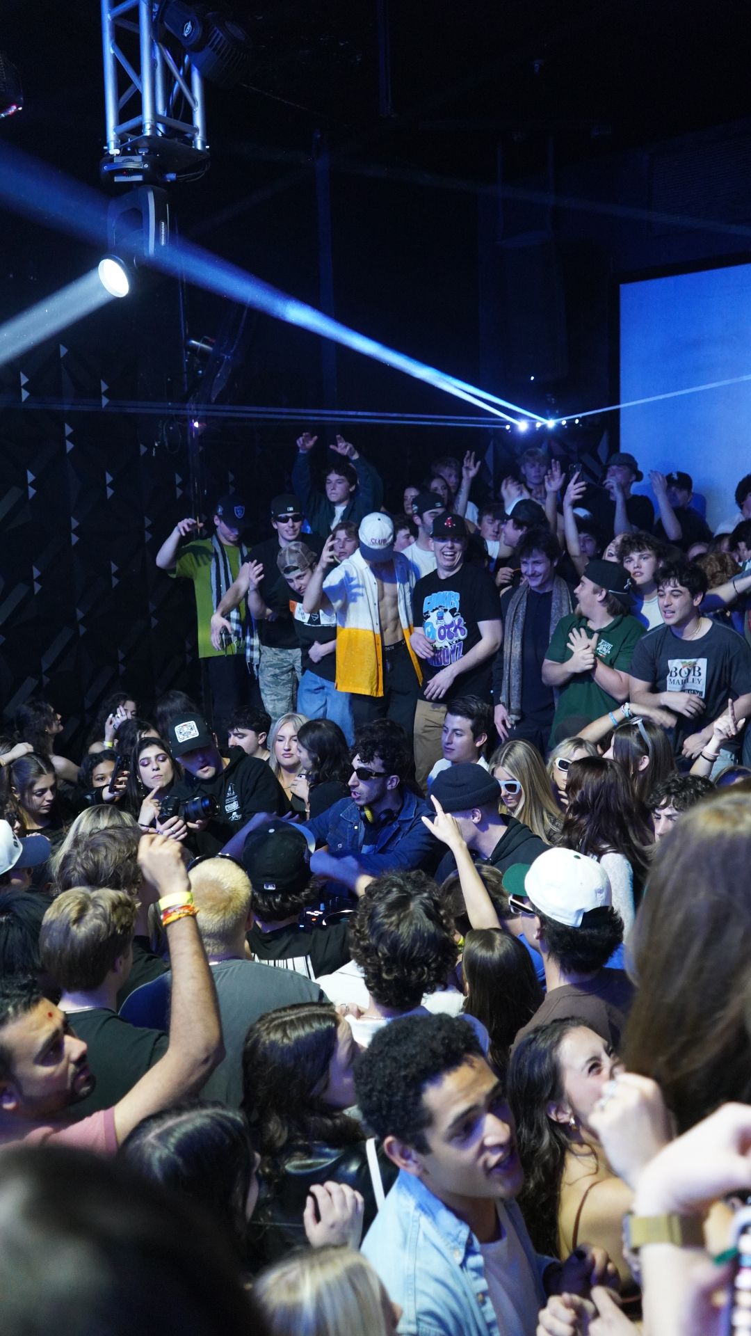 Packed crowd at a Masjedi Events gig with stage lights