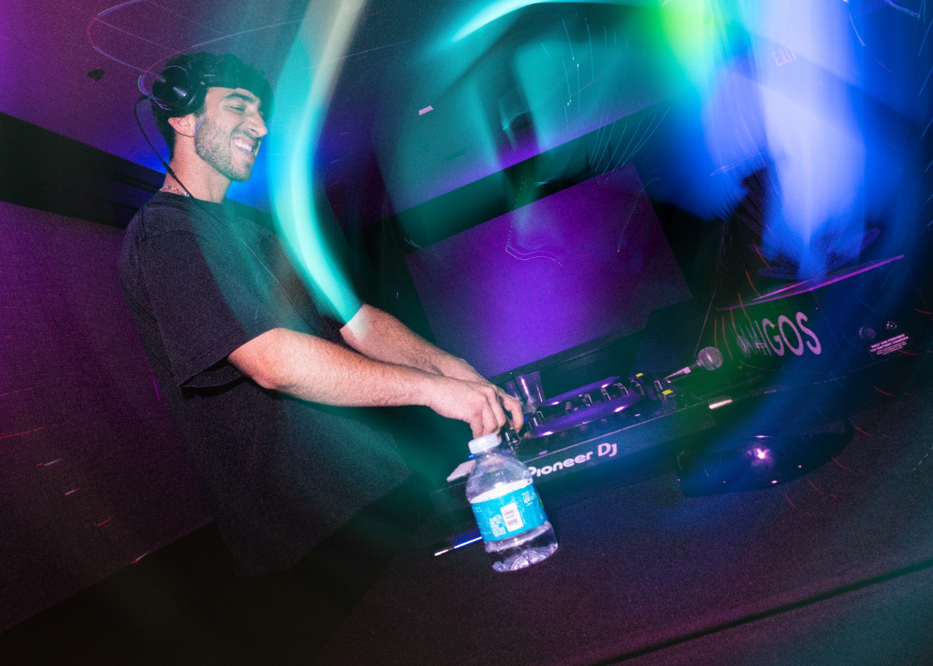 Masjedi Events DJ mixing under stage lights